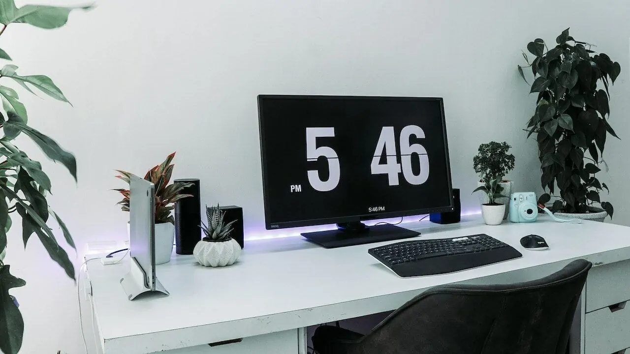 zwarte monitor aan bureau laat cijfers 5:46 zien