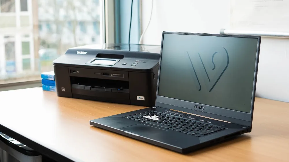 Laptop met printer op bureau, vooraanzicht
